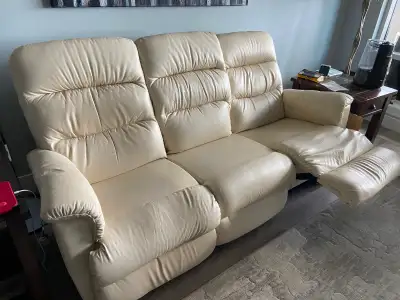 Cream coloured three seat sofa with two seat reclining. Everything works like new. No tears or abras...