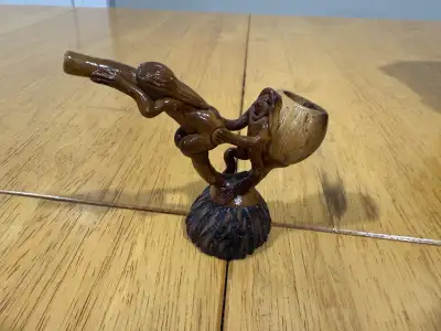 Check out this unique, used clay pipe, featuring detailed carvings of figures, perfect for collector...