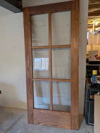 Solid wood glass panel door. Was custom built and cost around $1000. We were planning to hang it as...