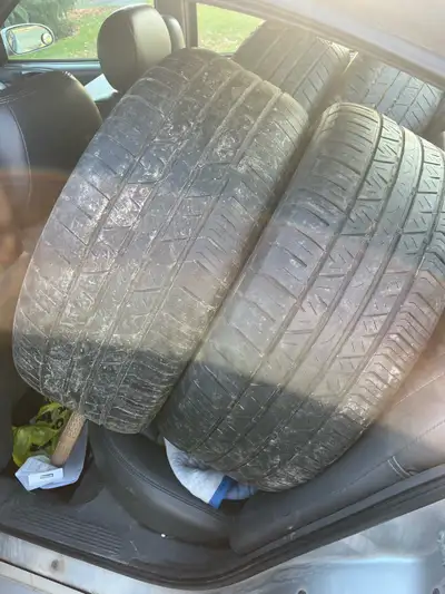 These tires are in used condition, showing signs of wear across the tread. They are ready for their...