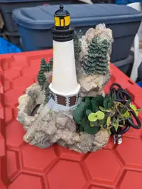 A really cute lighthouse water fountain about 14 in tall 12 in w