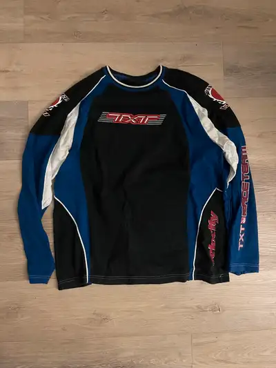 I'm selling a TXT Velocity Team long-sleeve shirt, perfect for fans or collectors. It's in good cond...