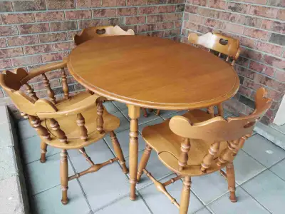 Oval shape all wood table and 4 chairs (one arm chair), table measures 48" x 36", asking $180 for th...
