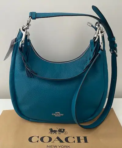 Brand new beautiful turquoise teal colour medium size COACH leather bag. The adjustable strap for we...