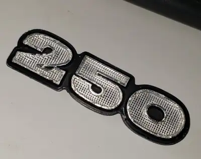 FOR SALE: Original, used, Kawasaki S1 250 side cover emblem/badge. Metal. Numbering outer ridge has...