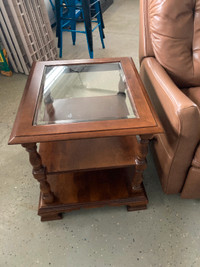 Solid wood end table with glass top.