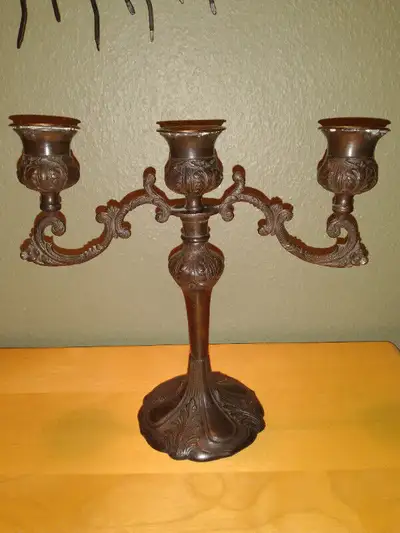 Vintage black colored brass candelabra., View more