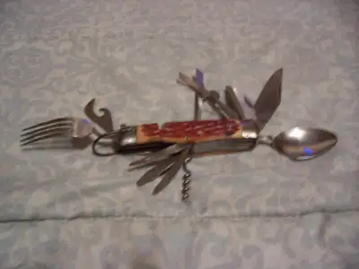 Large camping knife with 10 utensils including spoon, fork, knife, file, scissors, etc. This knife h...