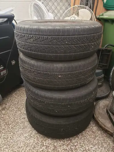 Set of four Yokohama tires, size 225/65R16, mounted on steel rims. These tires are used and show sig...