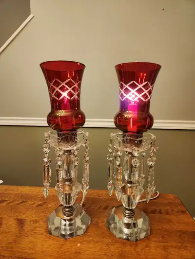 A pair of cranberry glass lamps with hanging crystal prisms. Victorian style boudoir, hallway, desk...