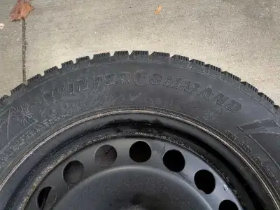 Goodyear Winter Command 215/65R17 winter tires mounted on steel rims with a 5x112 spoke pattern. Ple...