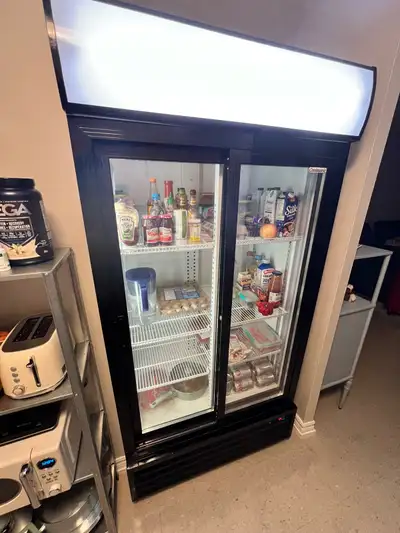 Sliding 2-door commercial fridge, 6 racks, strip light on right side is out, otherwise works wonderf...