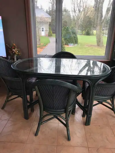Table en rotin avec 4 chaises de marque Kudos. 35 po. de large X 59 po. de long. Vitre en verre trem...