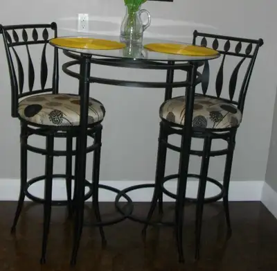 Stylish Pub-Height Dining Set $95 All metal, and the chairs swivel. Table is 42” high with a round g...