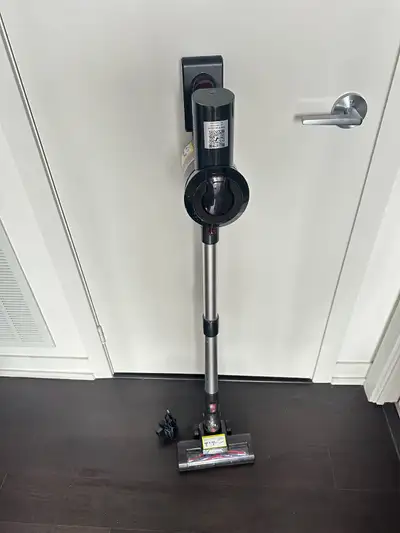 Cordless stick vacuum has a black and silver finish. This Tineco model includes a motorized floor he...