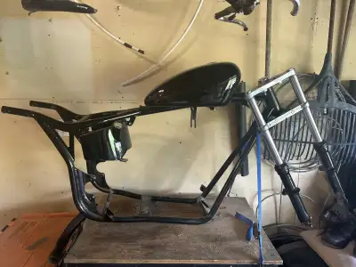 I am selling motorcycle parts including a frame, gas tank ,front forks , fenders front and back tire...