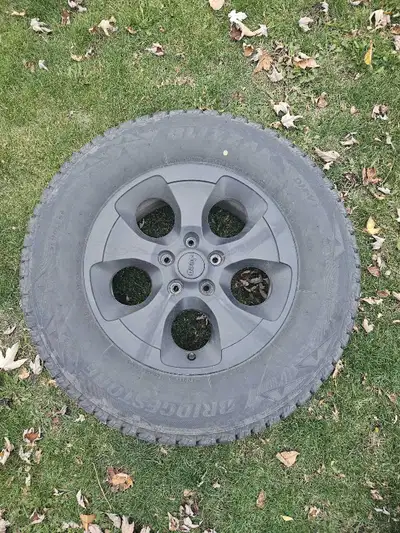 Set of 4 Bridgestone Blizzak winter tires. 255 70 18 Used 1 season on Sahara Unlimited rims, plasti...