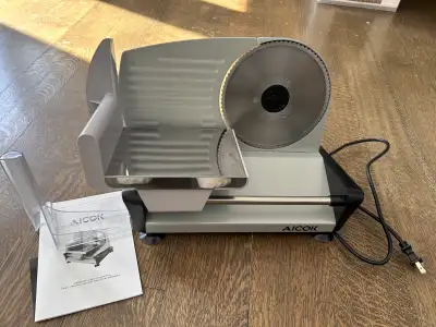 I'm selling an Aicok meat slicer, featuring a stainless steel blade for consistent, precise cuts. Th...