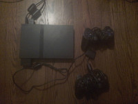 PlayStation 2 slim console and 2 controllers