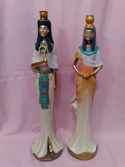A pair of large, vintage hand-painted ceramic Egyptian figurines of king and queen. They are both in...