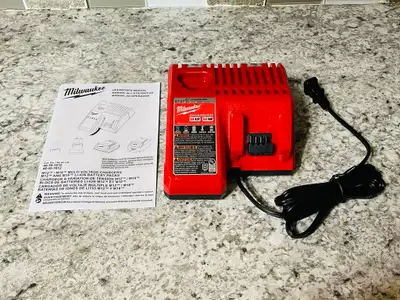 Brand new (unused) authentic Milwaukee 48-59-1812 dual M12 - M18 battery charger that was just remov...