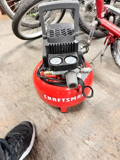 This is a Craftsman air compressor with a portable design and a red tank, perfect for small jobs aro...