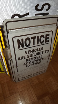 "NOTICE" SIGN:VEHICLES ARE SUBJECT TO REMOVAL AT OWNERS EXPENSE