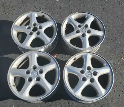 Here we have a set of 4 OEM aluminum alloy wheels for a Mazda Protegé, specifically a 2001-2003 mode...