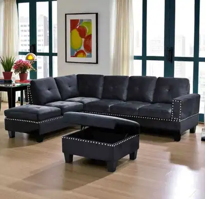 This used sectional sofa features a modern design with studded trim and includes a storage ottoman,...