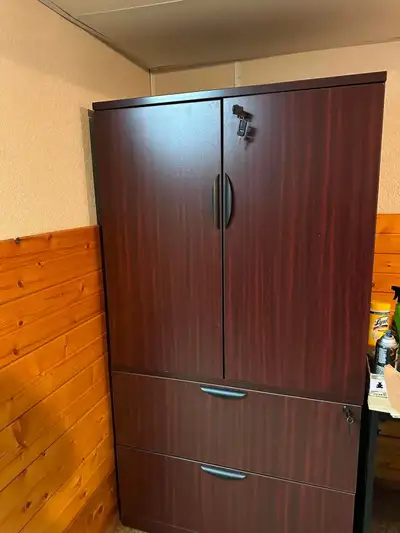 This pre-owned storage cabinet features a rich dark cherry finish, providing both elegance and funct...