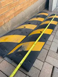 two rubber 6'x1'x2" Uline speed bumps