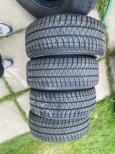A set of 4 Top of the line Bridgestone Winter Tires with tons of tread barley driven in like new con...