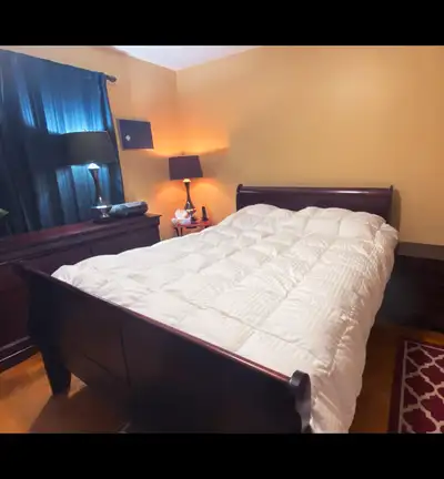 Nice king size dark wood bedroom set. Includes a headboard, bed frame & boxspring, one nightstand, a...