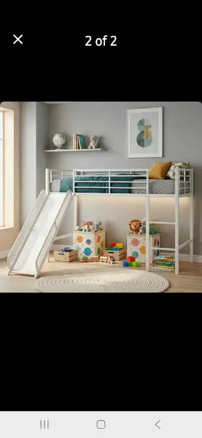 Durable metal loft bed with a slide and ladder. This gray frame includes safety rails and a space-sa...