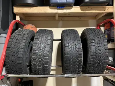 Offering a set of four used Firestone Winterforce winter tires, size 195/65R15, mounted on steel rim...