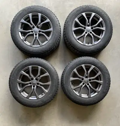 Complete set of 4 Bridgestone Blizzak DM-V2 winter tires mounted on DAI ARC DW69 alloy rims. Ready t...