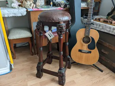 Carved lion-head hardwood stool.