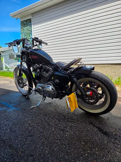 This 1200cc Sportster has been customized into a clean bobber-style build with serious presence and...