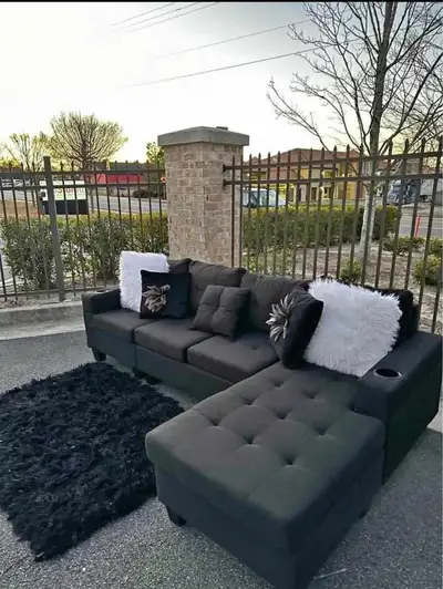 This , stylish dark grey sectional sofa features a versatile design that can be configured to your l...