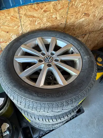 These pre-owned 16-inch Volkswagen wheels wrapped in Continental VikingContact 7 winter tires are re...