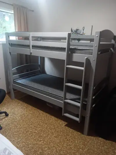 Wood frame and Includes 2 twin mattresses used sparingly by grandkids visiting.