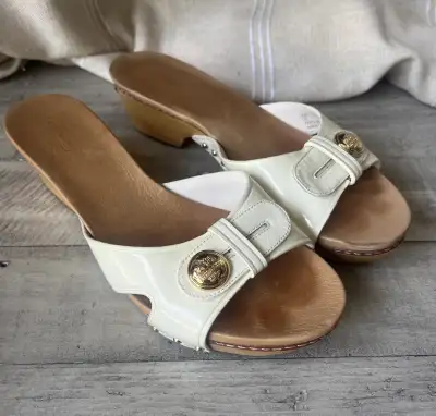 Elevate your summer style with these Coach sandals, featuring a chic wedge heel and a glossy white f...