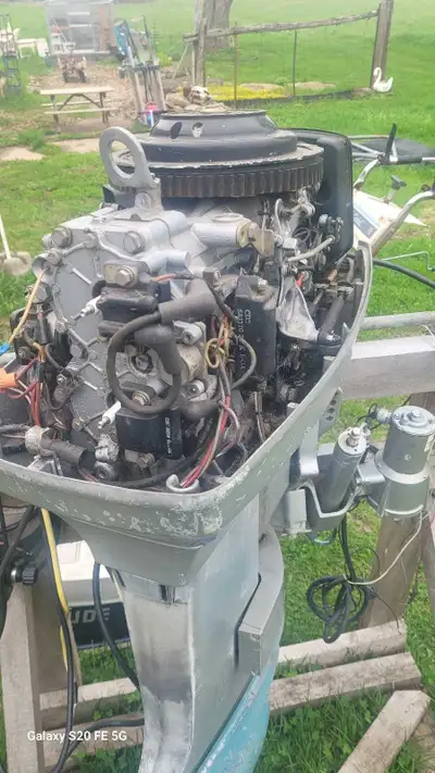 1980's 50hp evinrude with controls Part or fix. Will fire with gas in carb. Needs fuel pump. And a c...