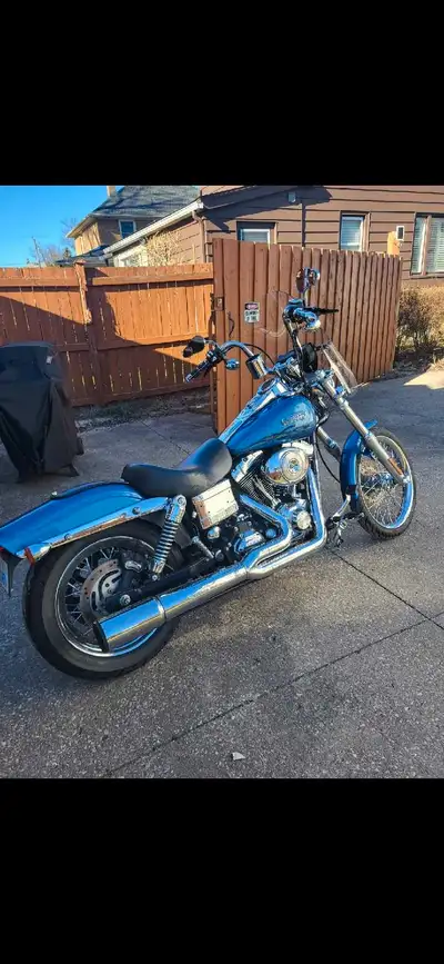 2006 Dyna Wideglide. Meticulously cared for Blue pearl paint with chrome laced mag wheels with new P...