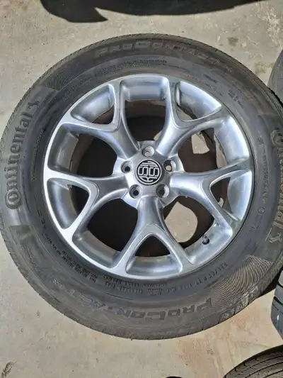 Good conditions continental tires and alloy rims set of 4 we just used for 2 summer have 95% tread w...