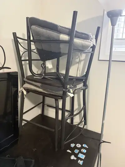 This set includes two used bar-height chairs and a torchiere style floor lamp. The chairs feature a...