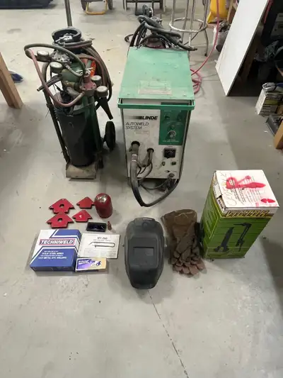 Mig 200 welder, cutting torch with cart and all owned tanks. Mis parts and tools, selling as a packa...