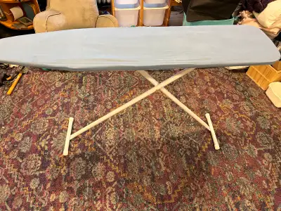 Adjustable height ironing board, padded w/ washable cover. Folds flat for storage. Cash only Smoke f...