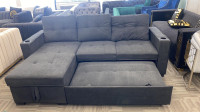 Pullout sectional couch in grey.