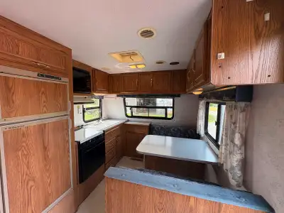 Front Kitchen rear bedroom 1995 24C Prowler . two-way Fridge re-cored 4 years ago and works well fur...